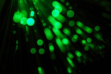 Green bokeh effect background. Light splash on black background.の写真素材