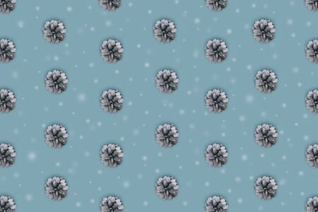 Silver Christmas tree cones on blue backdrop with snow. Christmas and new year pattern. Flat lay...