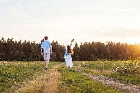 A couple in love dance in the field. Sunset light.の写真素材