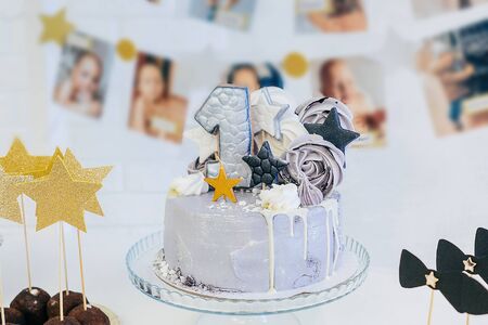 First birthday cake with golden stars. Gray, black and golden colors.の写真素材