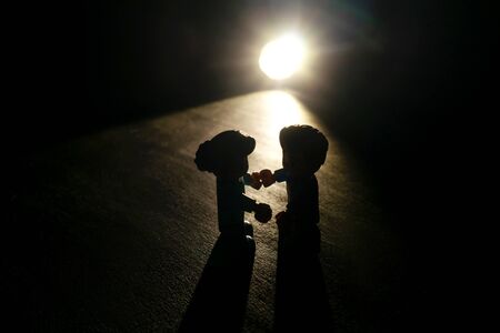 Loving couple toys silhouette in dark. Back light.