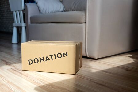 Donation box closed in sunshine on floor. Home interior.の写真素材