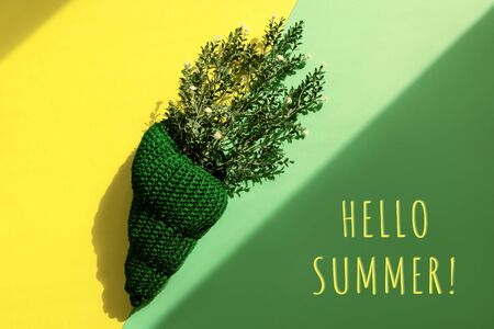 Knitted shell with branch decorating on yellow and green. Sunshine and shadows. Hellow summer concept.の写真素材