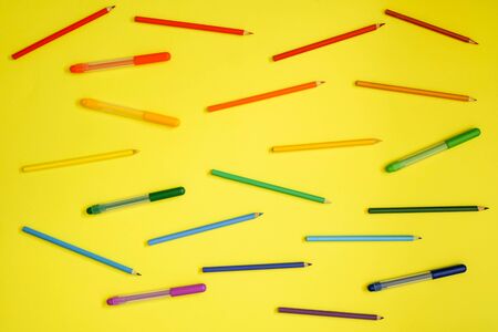 Stationery on yellow. Flat lay. Rows of tools, gradient rainbow colors.の写真素材