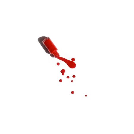 Spilled red nail polish with bottle isolated on white background.の写真素材