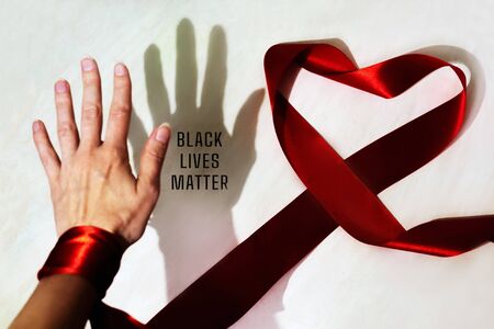 Black shadow and white palm and inscription Black Lives Matter. Heart from red ribbon. Equal Symbol. No racism concept.の写真素材