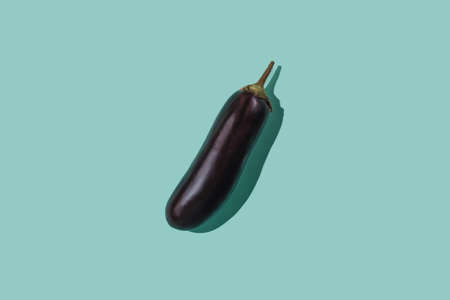eggplant on pastel turquoise background. Single vegatable on solid background.の写真素材