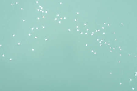 White stars on turquoise backdrop. Festive concept. Flat lay style.の写真素材