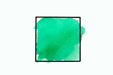 Green brush strokes watercolor paint in black fame isolated on white background. Copy space.の写真素材