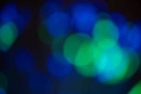 Green and blue light bokeh in black background. Copy space.の写真素材