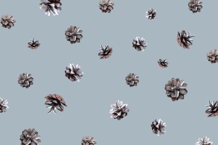 Hello winter concept. Winter pattern with flying silver pine cones on blue background. Zero gravity concept. Copy space.の写真素材