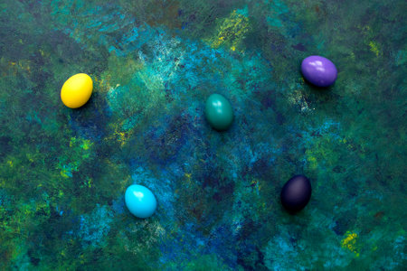 Color easter eggs on blue oil paint mixed background. Easter hipster concept.の写真素材