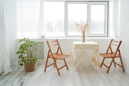 Table and two chair. Beautiful light and wooden interior. Cozy home, minimilaism. Table and two chair.の写真素材