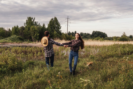 A couple in love in the field. Man and woman dance, funny play.の写真素材