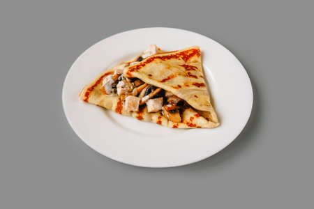 Crepe with filling on gray. Tasty breakfast.の写真素材