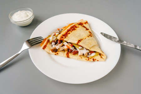 Crepe with filling on gray. Tasty breakfast.の写真素材