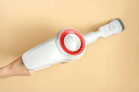 Female hand holding a portable vacuum cleaner.の写真素材