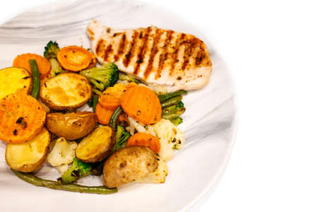 Grilled vegetables and chicken fillet on plate.の写真素材