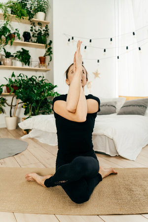 Portrait of beautiful woman practicing yoga indoor.
