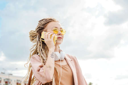 Woman with dreadlocks outdoor. Sunny summer day.の写真素材