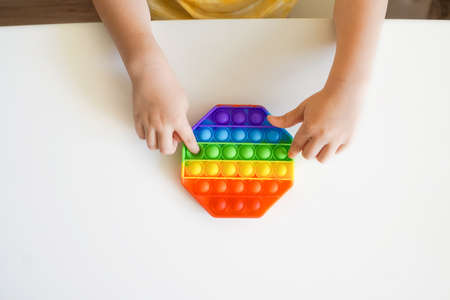 Colorful Pop it fidget in kids hands.の写真素材