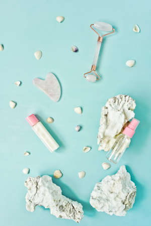 Gua Sha massager, roller on blue background.の写真素材