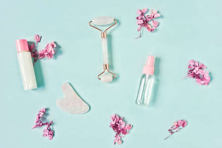 Gua Sha massager, roller on blue background.の写真素材