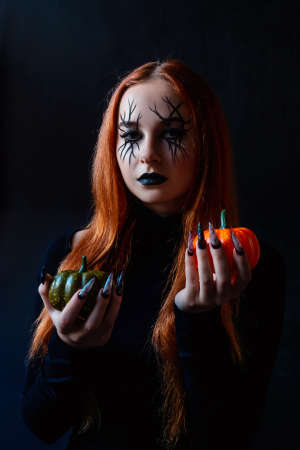 Halloween witch woman with long nails and make-up.の写真素材