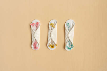 Reusable eco natural pad with flowers on beige.の写真素材