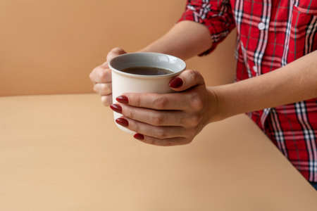 Close up of hands holding cup tea.の写真素材