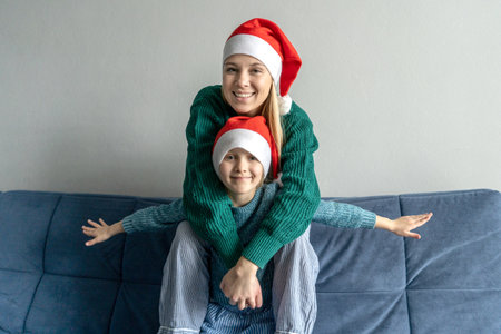 little girl and mother in Santa hatsの写真素材