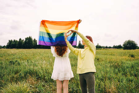 Couple holding  flag, rear view.の写真素材
