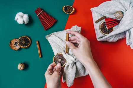 Woman hands wrapping Furoshiki gifts. Zero waste.の写真素材