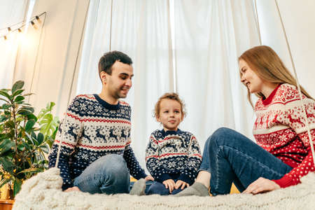 Happy family have fun on bed. Home.の写真素材