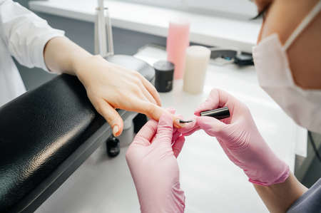Young woman getting manicure in beauty salonの写真素材