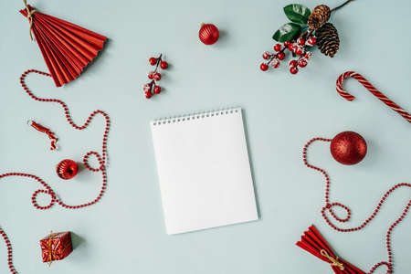 Red Christmas baubles decoration around blank notebook.の写真素材