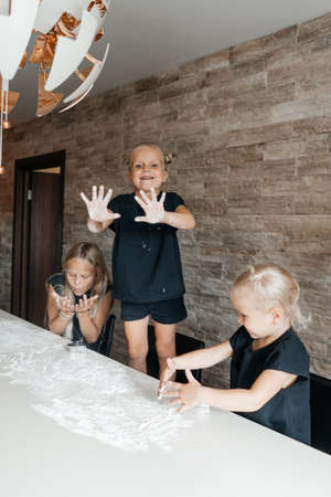 Children making cookies in the kitchen at home.の写真素材