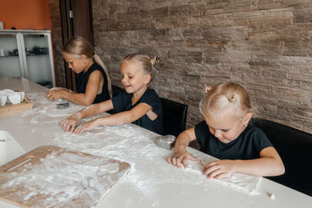 Children making cookies in the kitchen at home.の写真素材