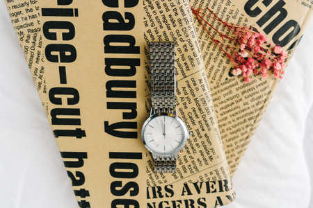 Silver watch on cover book top view.の写真素材