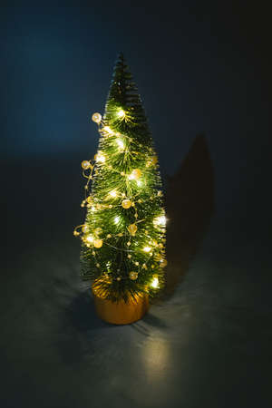 Illuminated christmas tree toy in dark. Vertical.の写真素材