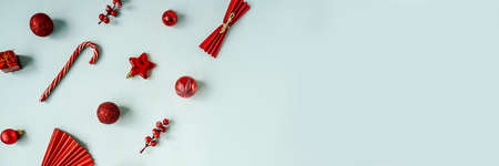 Red Christmas baubles decoration on blue background.の写真素材