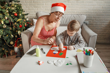 A Little boy with grandmom make greeting card.の写真素材