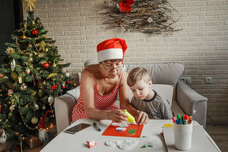 A Little boy with grandmom make greeting card.の写真素材