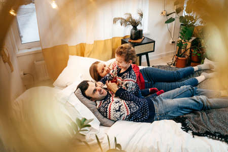Happy family have fun on bed. Home.の写真素材