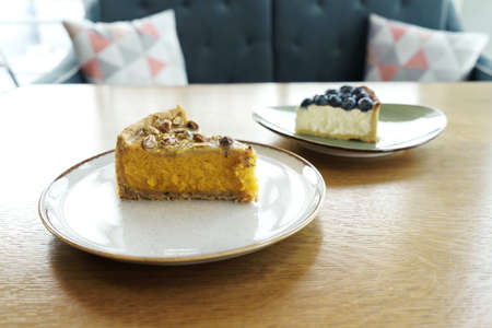 Two pieces of desserts on brown table. Front view.の写真素材