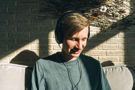 Portrait happy smiling man in headphones at home.の写真素材