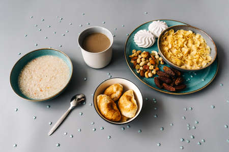 Bright breakfast, trendy dishes turquoise color on gray.の写真素材