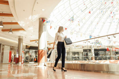 Business woman with shopping bags in mall.の写真素材