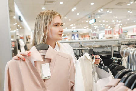 Woman in the mall chooses a blouse.の写真素材