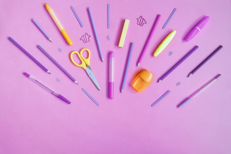 Violet and yellow stationery on pink. Flat lay.の写真素材